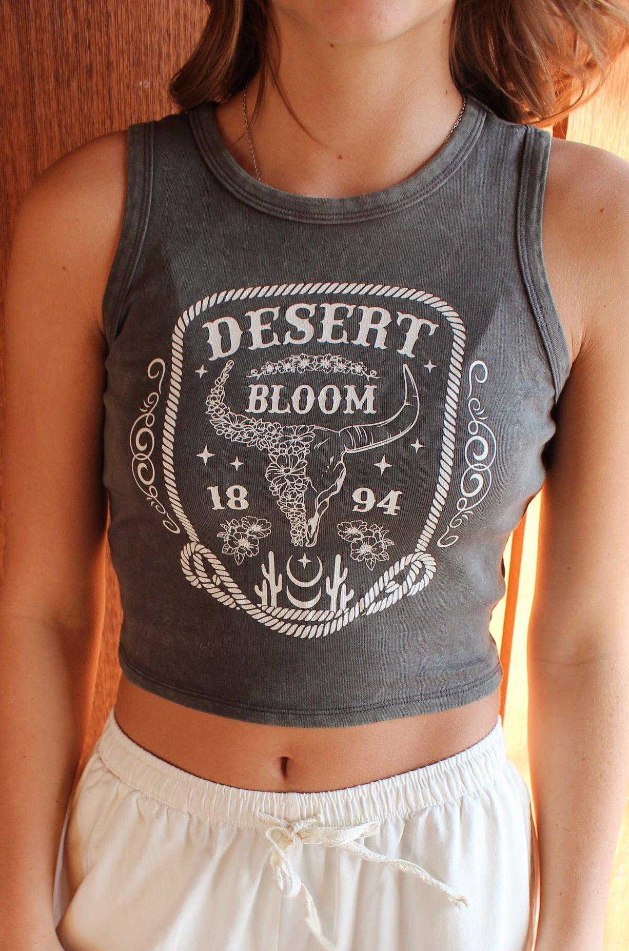 Desert Bloom western graphic crop tank with cow skull design
