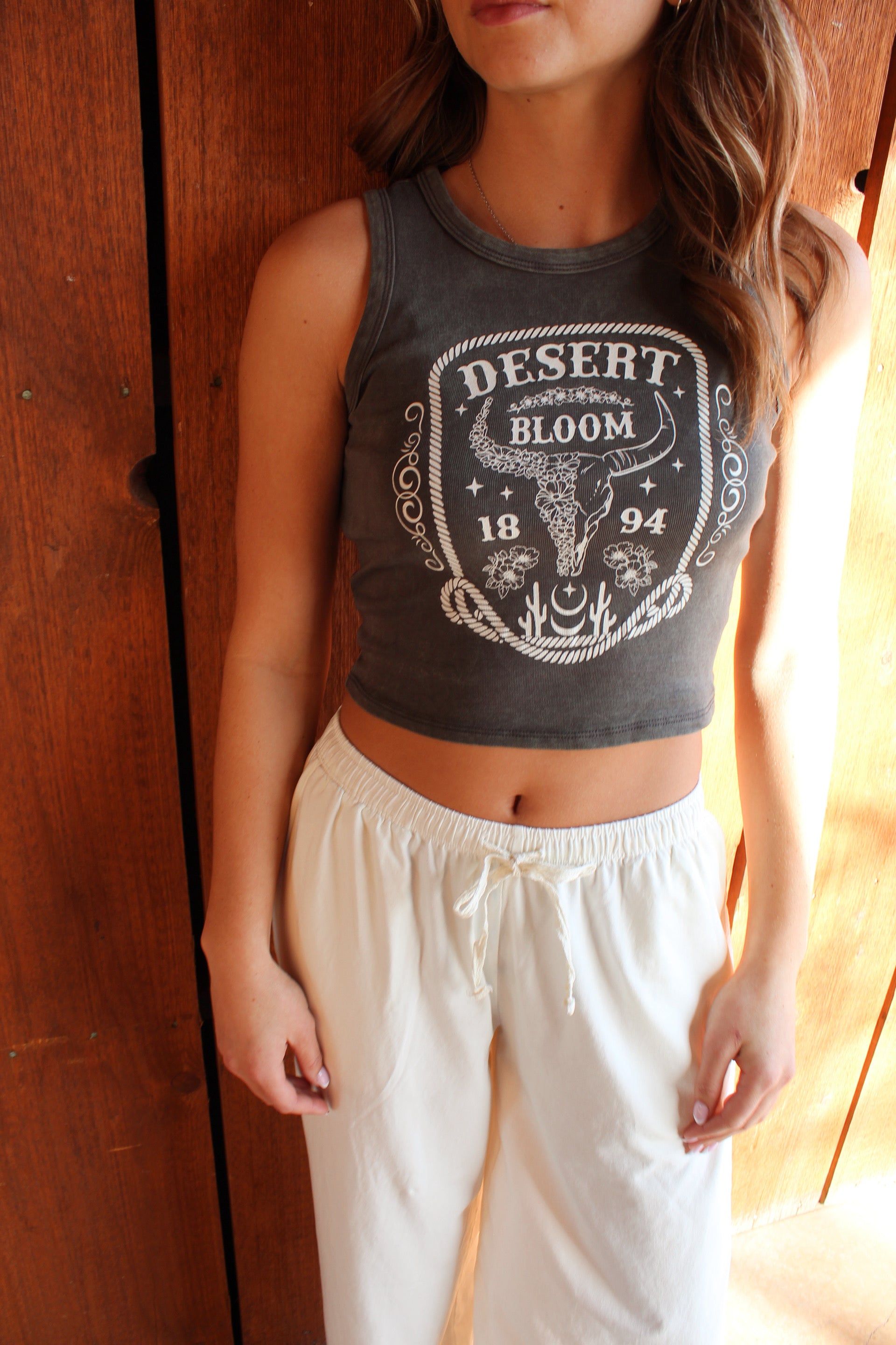 Desert Bloom western graphic crop tank with cow skull design
