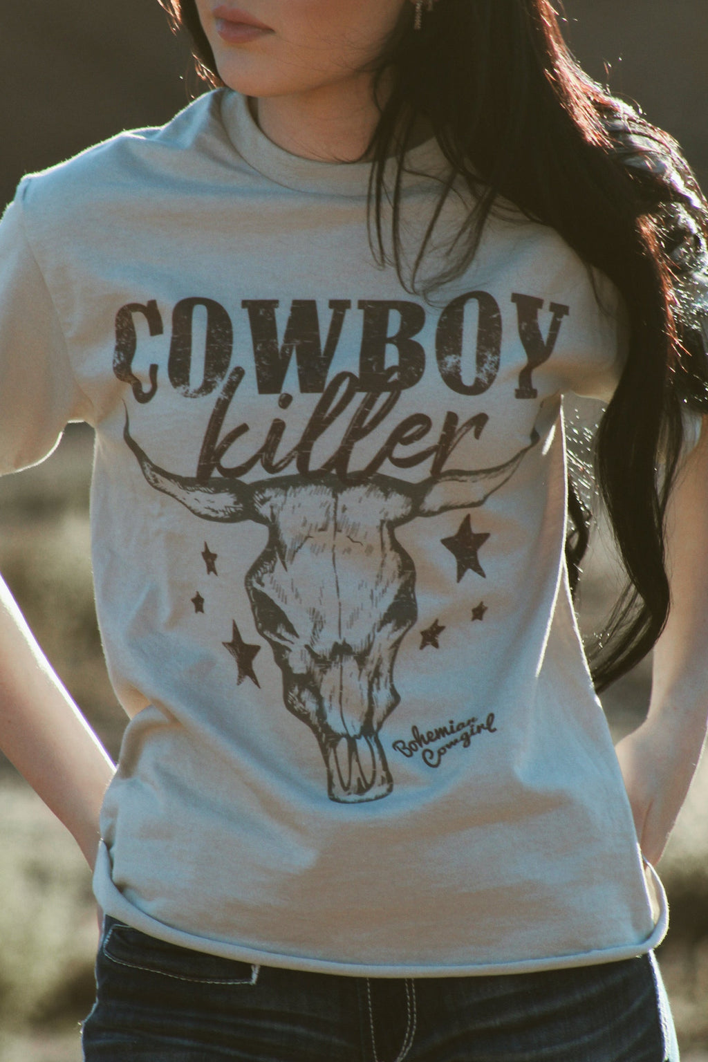 Bohemian cowgirl graphic tee with cowboy killer lettering and longhorn skull design