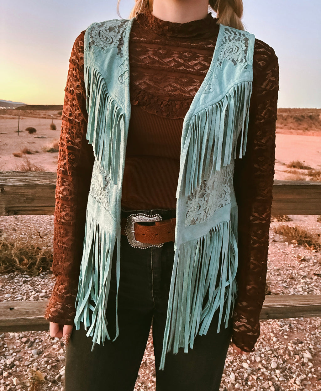 Vocal turquoise fringe lace vest layered over lace top with western cowgirl styling