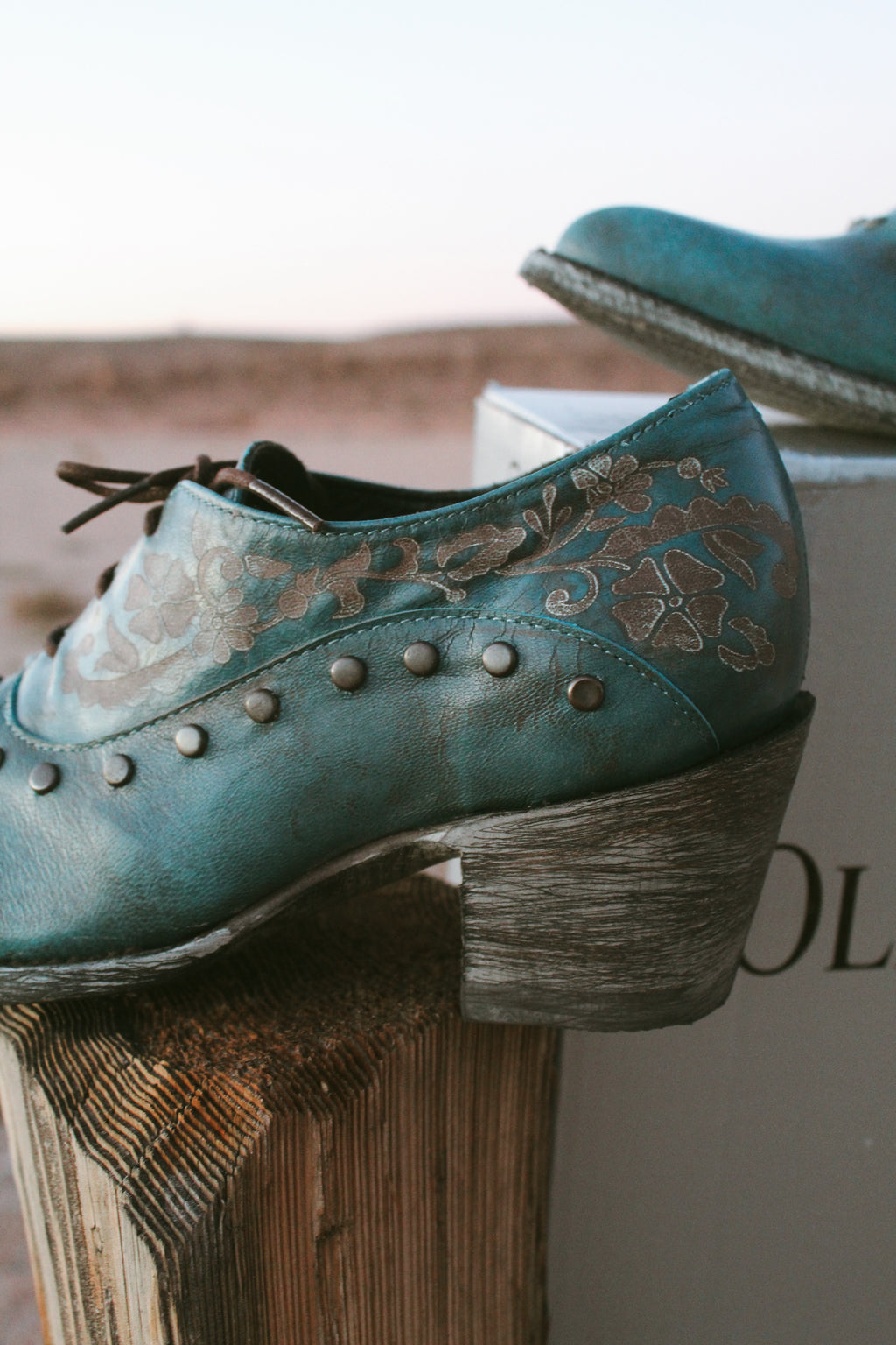 Old Gringo teal embossed leather western booties with studded details and wooden heel styled.