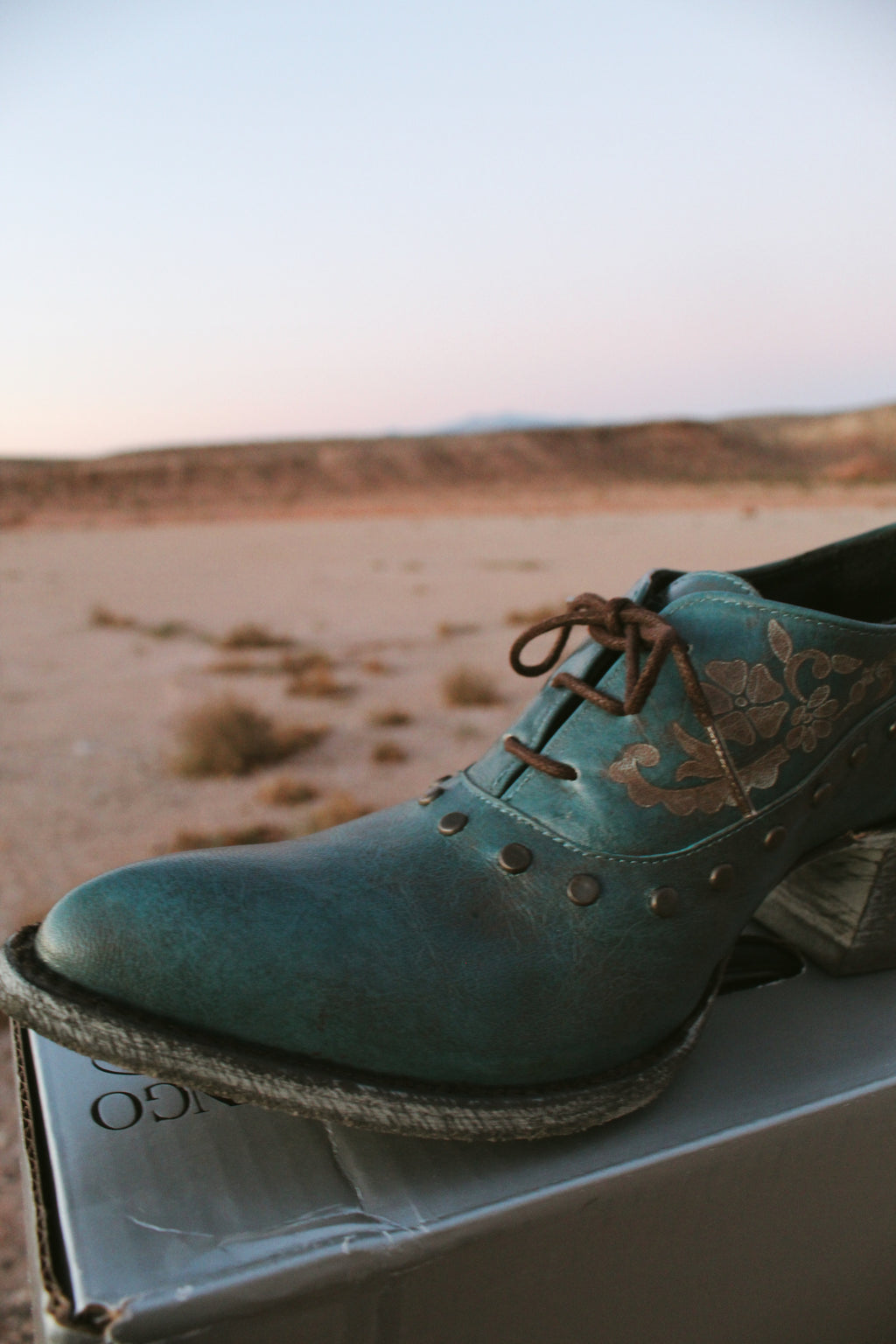 Old Gringo teal embossed leather western booties with studded details and wooden heel styled.