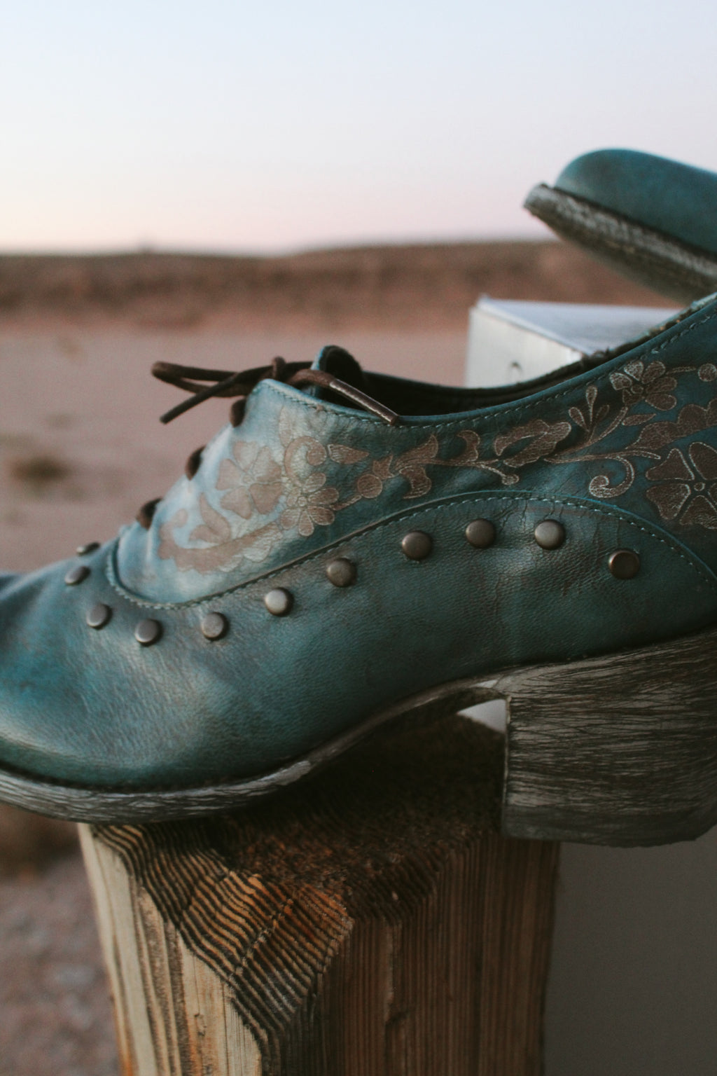 Old Gringo teal embossed leather western booties with studded details and wooden heel styled.