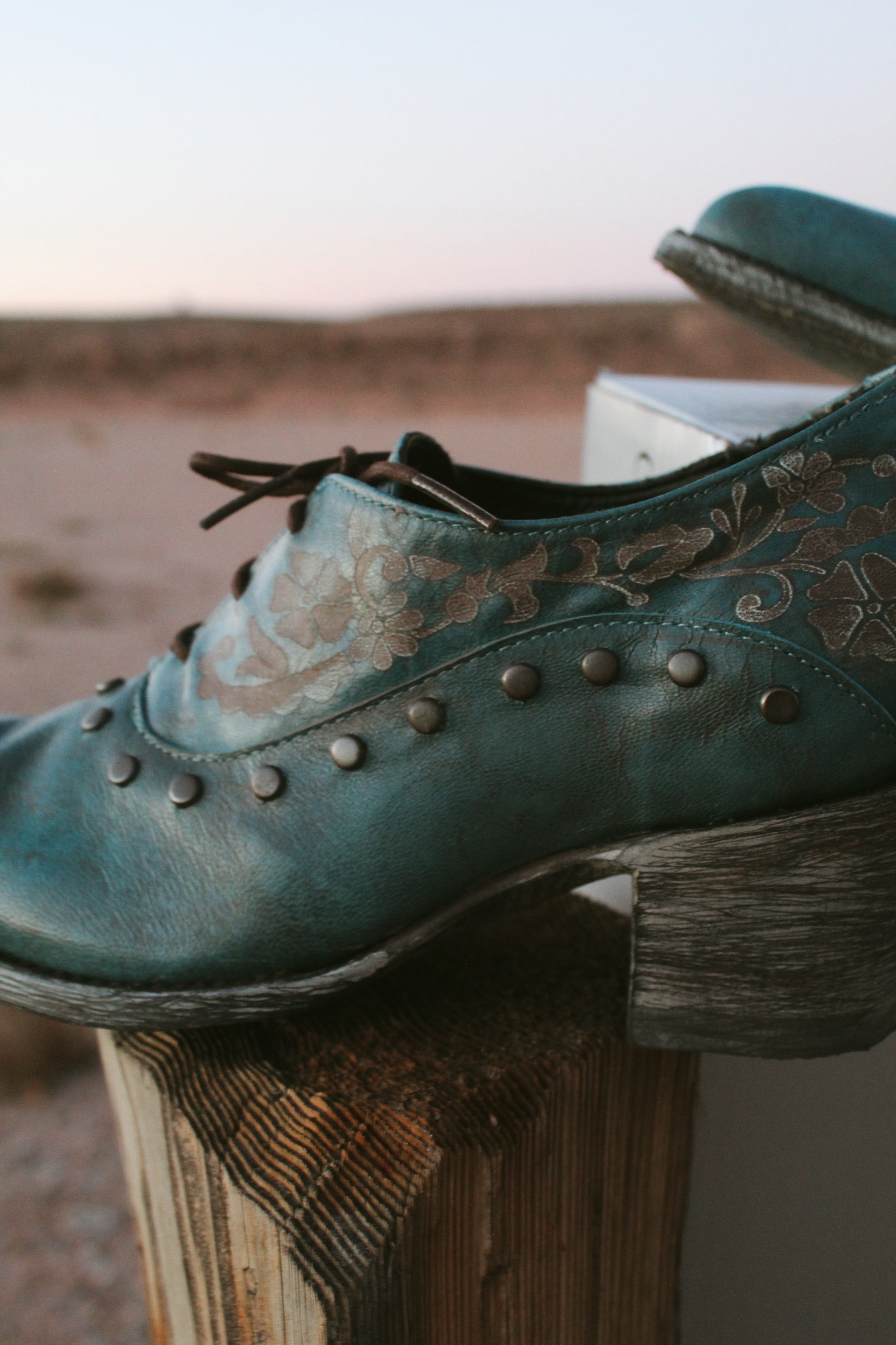 Old Gringo teal embossed leather western booties with studded details and wooden heel styled.